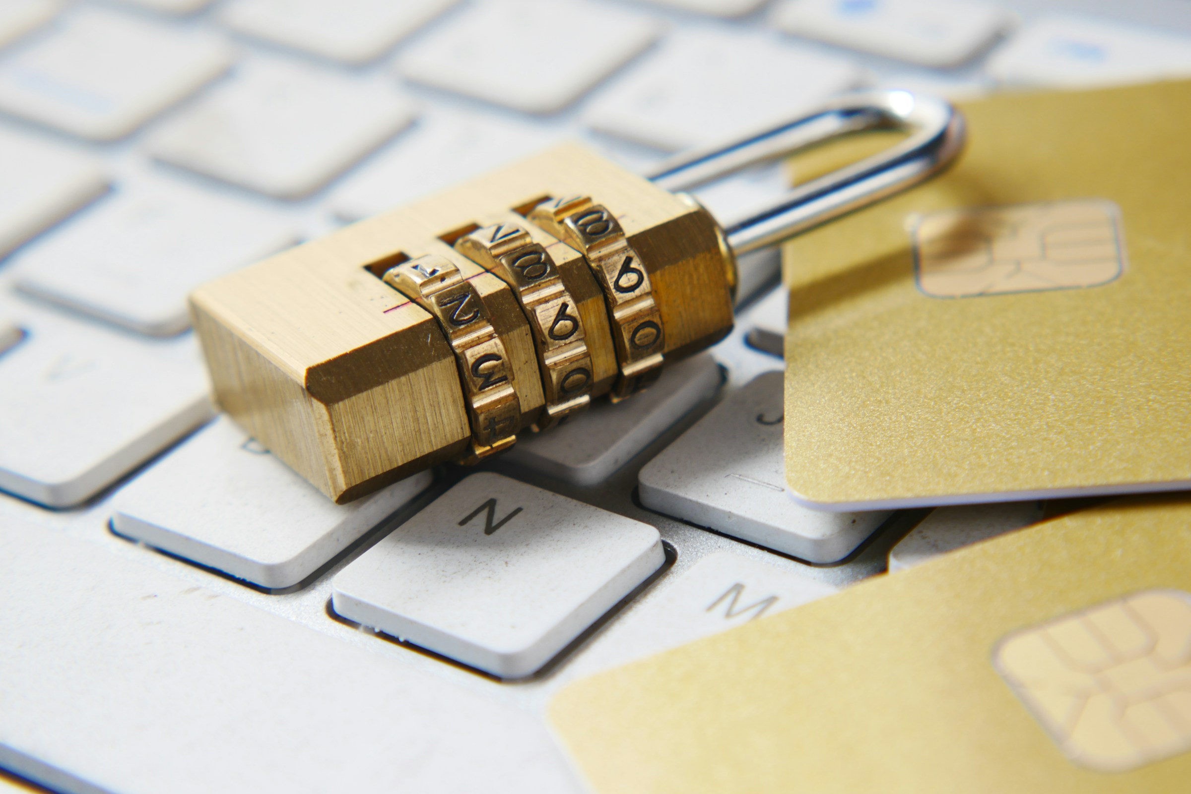 Padlock and credit cards on keyboard, representing hoe to recover from identity theft.